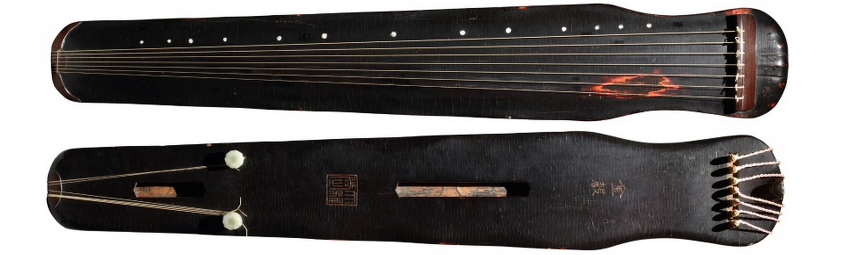 Guqin placed in a minimalist space with sunlight on its strings